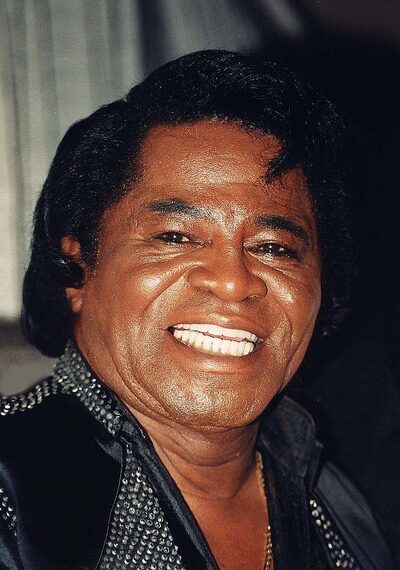 James Brown performing energetically on stage