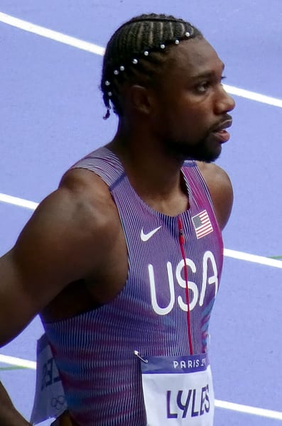 Noah Lyles celebrating at the finish line