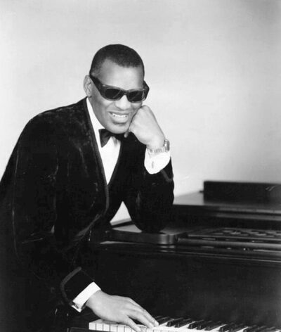 Ray Charles at his piano with his signature sunglasses